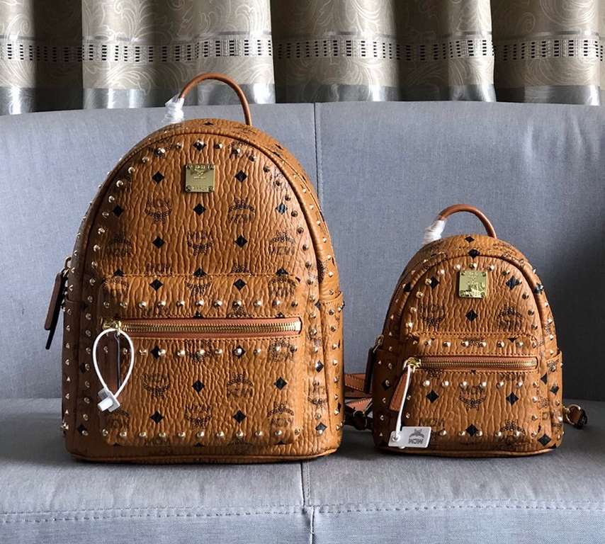 Code 5917-5718-5919. [MCM] Stark Visetos studded duffel bag in a classic Visetos print with metal rivets outlining the print. Crafted from lightweight bond-coated canvas and designed in a classic Visetos print, the pract