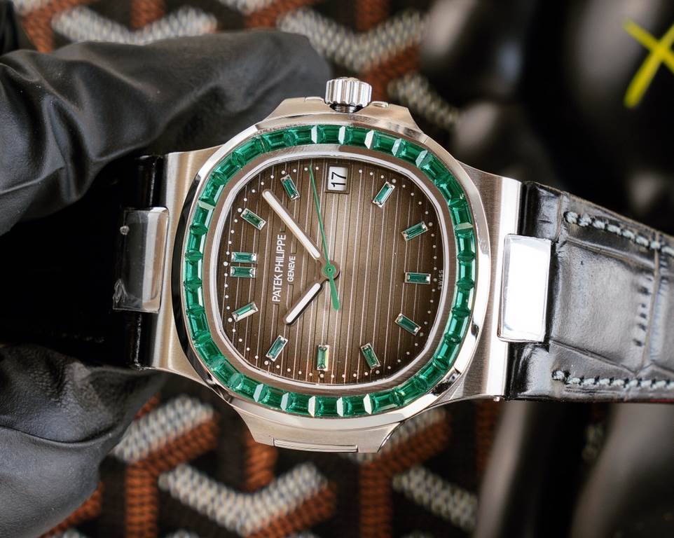 Patek Philippe 5711113P-01 Nautilus, the king of steel watches, is available in a limited edition. The octagonal square bezel is set with emerald and ruby baguettes of exceptional color. Horizontal cross-grained dial set