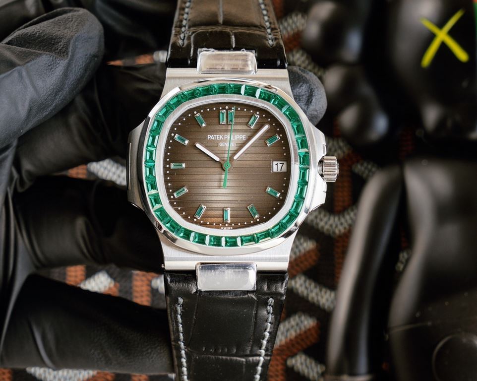 Patek Philippe 5711113P-01 Nautilus, the king of steel watches, is available in a limited edition. The octagonal square bezel is set with emerald and ruby baguettes of exceptional color. Horizontal cross-grained dial set