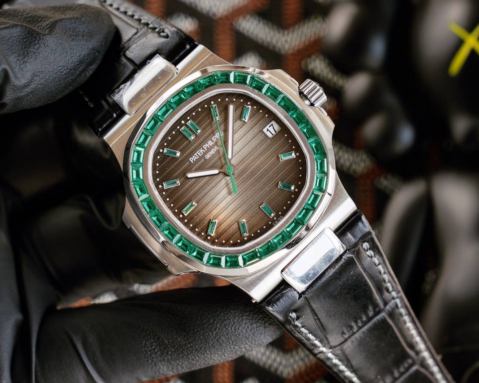 Patek Philippe 5711113P-01 Nautilus, the king of steel watches, is available in a limited edition. The octagonal square bezel is set with emerald and ruby baguettes of exceptional color. Horizontal cross-grained dial set