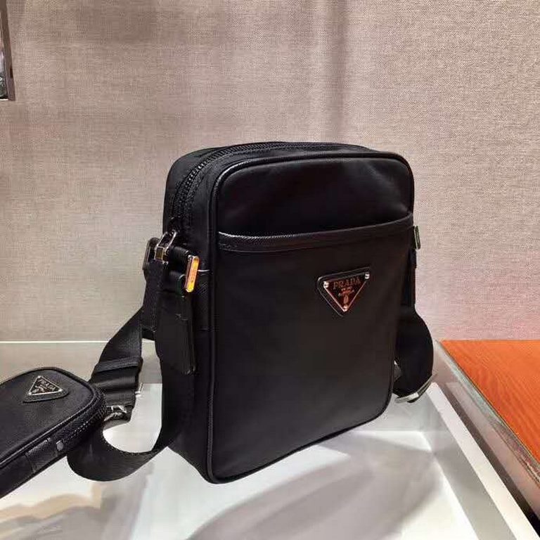 (Comes in a matching box) The newest addition to the P family! Model 2VH112This modern nylon crossbody bag is functional with a removable pouch charm and spacious interior compartments.Saffiano leather trim elevates the 