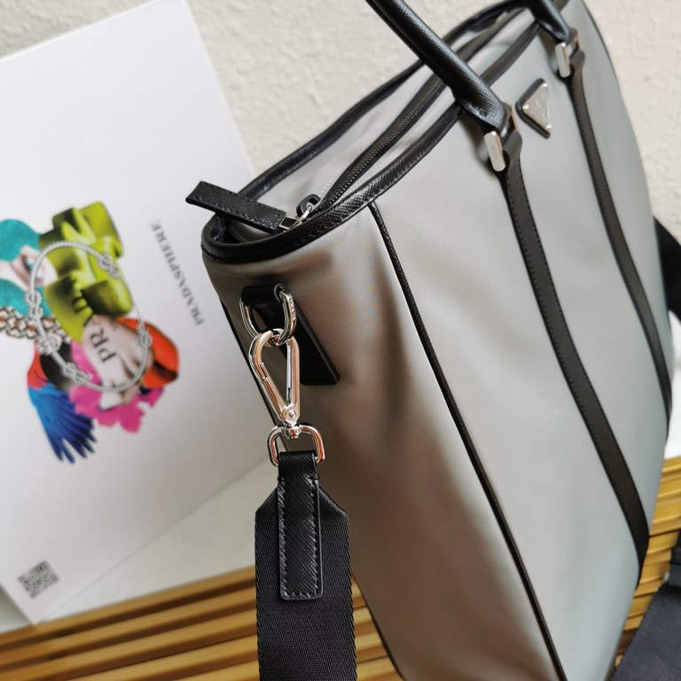 Made from a combination of imported nylon fabric and Saffiano cross grain cowhide leather, the handbag comes with a detachable shoulder strap to create a stylish look at your own pace. Simple and atmospheric, very practi