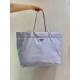 New Tote Bag 1BG107  This medium tote bag is crafted from innovative recycled nylon fabric for a minimalist and stylish design. Featuring a beautiful Saffiano leather carry handle, the bag is adorned with the iconic enam