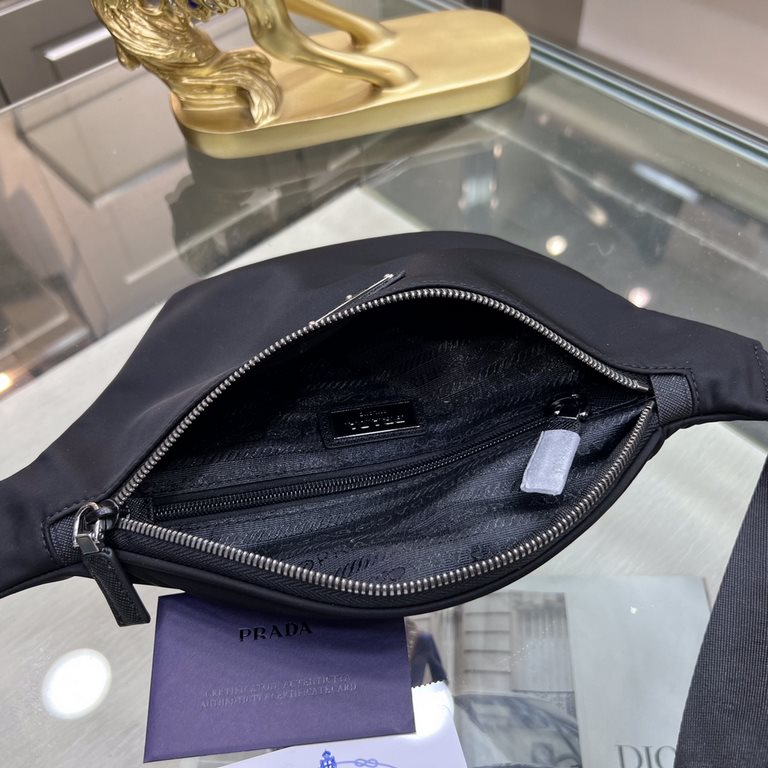 PRADA Prada  WaistChest Pack 2VL033  This fanny pack is crafted from Saffiano leather and Re-Nylon recycled nylon. The contemporary design borrows from streetwear style. Featuring an adjustable nylon waist belt, the bag 