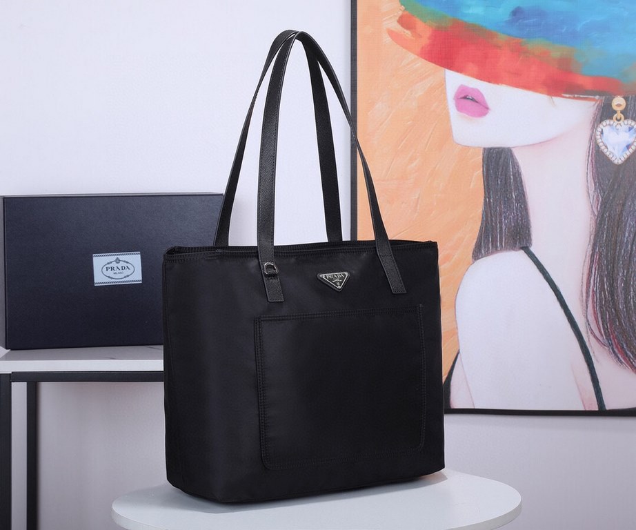 Lot   Tote Bag  1BG052    This nylon tote bag combines fashionable design and functionality with long Saffiano leather handles for a personalized touch, a two-way top zipper closure, a front exterior pocket, and two inte