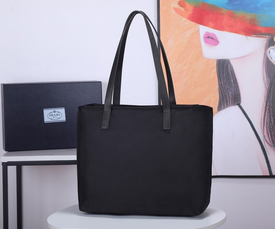 Lot   Tote Bag  1BG052    This nylon tote bag combines fashionable design and functionality with long Saffiano leather handles for a personalized touch, a two-way top zipper closure, a front exterior pocket, and two inte