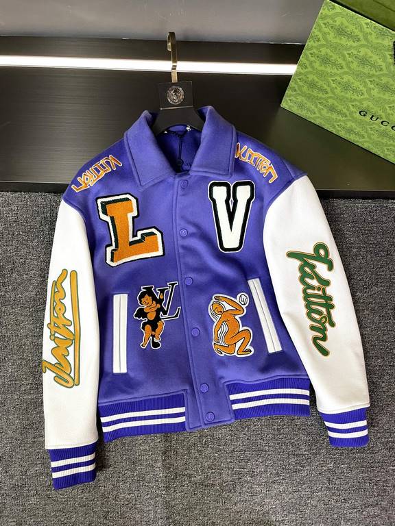 The Baseball Belted Jacket is made from LWG certified grained cowhide leather with an Australian wool body, embroidered appliqués with a colorful logo, a shirt collar, threaded sheep's wool cuffs, and a voluminous hemlin