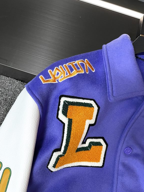 The Baseball Belted Jacket is made from LWG certified grained cowhide leather with an Australian wool body, embroidered appliqués with a colorful logo, a shirt collar, threaded sheep's wool cuffs, and a voluminous hemlin