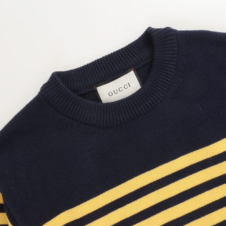 P220 Traditional motifs are reinterpreted through the Gucci aesthetic in a series of classic knitwear pieces. This sweater is crafted from jersey cotton and features bright blue and yellow stripes. The back is embellishe