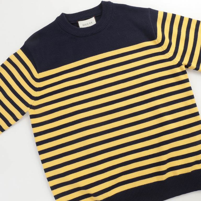 P220 Traditional motifs are reinterpreted through the Gucci aesthetic in a series of classic knitwear pieces. This sweater is crafted from jersey cotton and features bright blue and yellow stripes. The back is embellishe