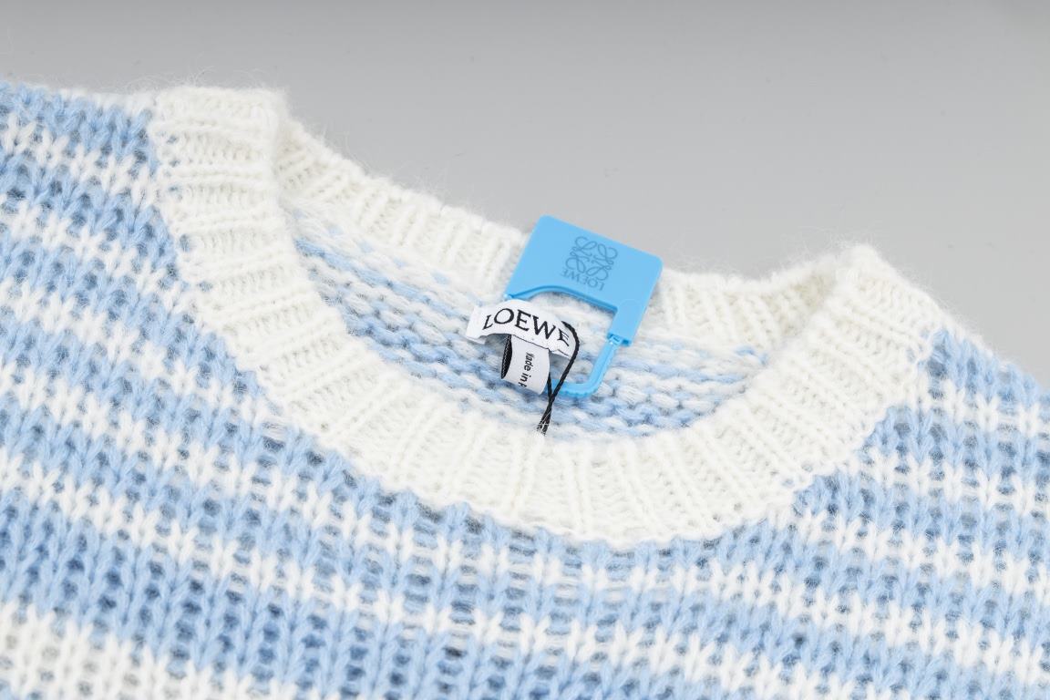 P235LOEW Striped colorblocked sweater with handmade appliquéd flowersBlue and white stripe color combinationThe loom makes the twisted stripes individually and then the lace is sewn by hand, which takes a long time.Size 