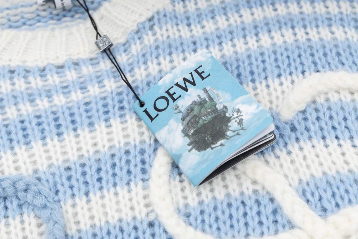 P235LOEW Striped colorblocked sweater with handmade appliquéd flowersBlue and white stripe color combinationThe loom makes the twisted stripes individually and then the lace is sewn by hand, which takes a long time.Size 