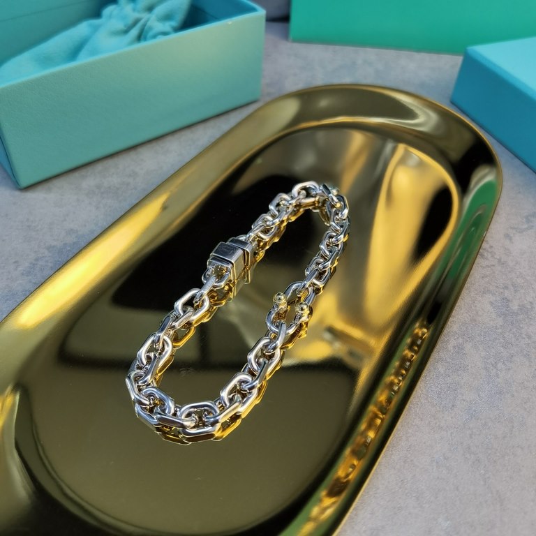 Crafted in sterling silver and white and yellow gold, this link bracelet showcases the pragmatism of classic American design, and the Tiffany 1837 Collection Makers, with its maker's mark, is inspired by the renowned Tif