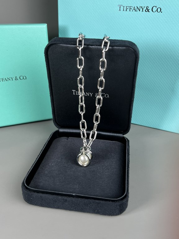 Tiffany. Tiffany This circle necklace with iridescent mother-of-pearl is a gift from nature. Elegant, glamorous and chic. The classic, glamorous Tiffany T Collection design is delicately faceted to reflect love.