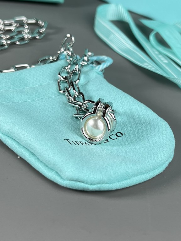 Tiffany. Tiffany This circle necklace with iridescent mother-of-pearl is a gift from nature. Elegant, glamorous and chic. The classic, glamorous Tiffany T Collection design is delicately faceted to reflect love.