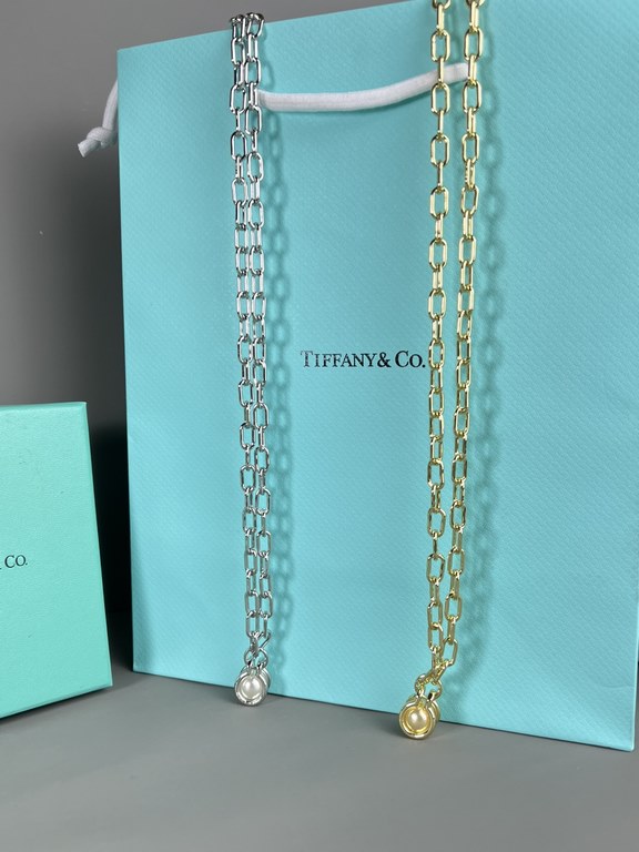 Tiffany. Tiffany This circle necklace with iridescent mother-of-pearl is a gift from nature. Elegant, glamorous and chic. The classic, glamorous Tiffany T Collection design is delicately faceted to reflect love.