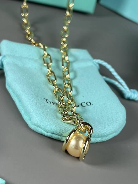 Tiffany. Tiffany This circle necklace with iridescent mother-of-pearl is a gift from nature. Elegant, glamorous and chic. The classic, glamorous Tiffany T Collection design is delicately faceted to reflect love.