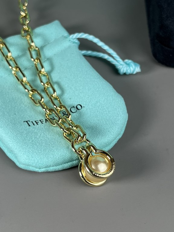 Tiffany. Tiffany This circle necklace with iridescent mother-of-pearl is a gift from nature. Elegant, glamorous and chic. The classic, glamorous Tiffany T Collection design is delicately faceted to reflect love.