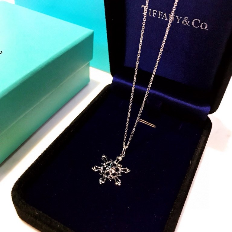 Tiffany Tiffany Snowflake necklace in 925 sterling silver. The snowflake symbolizes hope in the face of adversity, and also represents purity, beauty, and immaculateness. Seeing it on a hot summer day instantly makes you