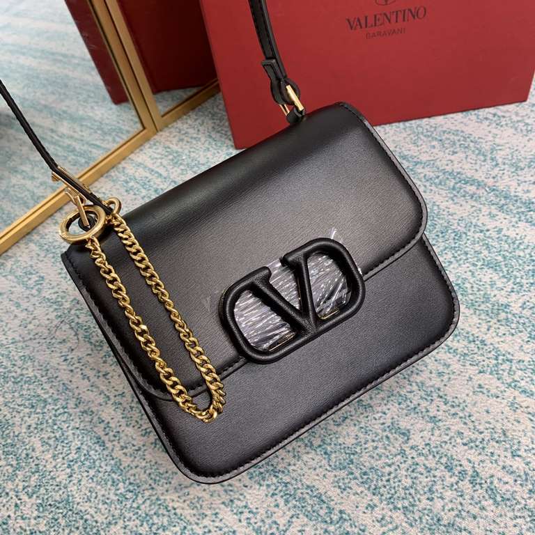 Small black buckle   model BOXValentino Garavani VSLING Shiny calf leather shoulder bag   with extendable shoulder strap for shoulder and crossbody use. Vintage brass-finished metal hardware Magnetic closure with leather